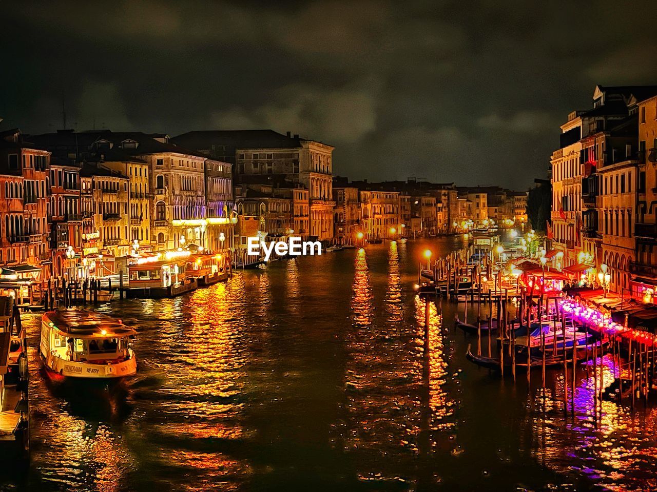 water, architecture, building exterior, night, reflection, city, cityscape, nautical vessel, illuminated, built structure, evening, transportation, sky, mode of transportation, building, nature, travel destinations, cloud, dusk, waterfront, canal, travel, no people, residential district, harbor, moored, ship, tourism, sea, city life, multi colored, outdoors, waterway, street, house