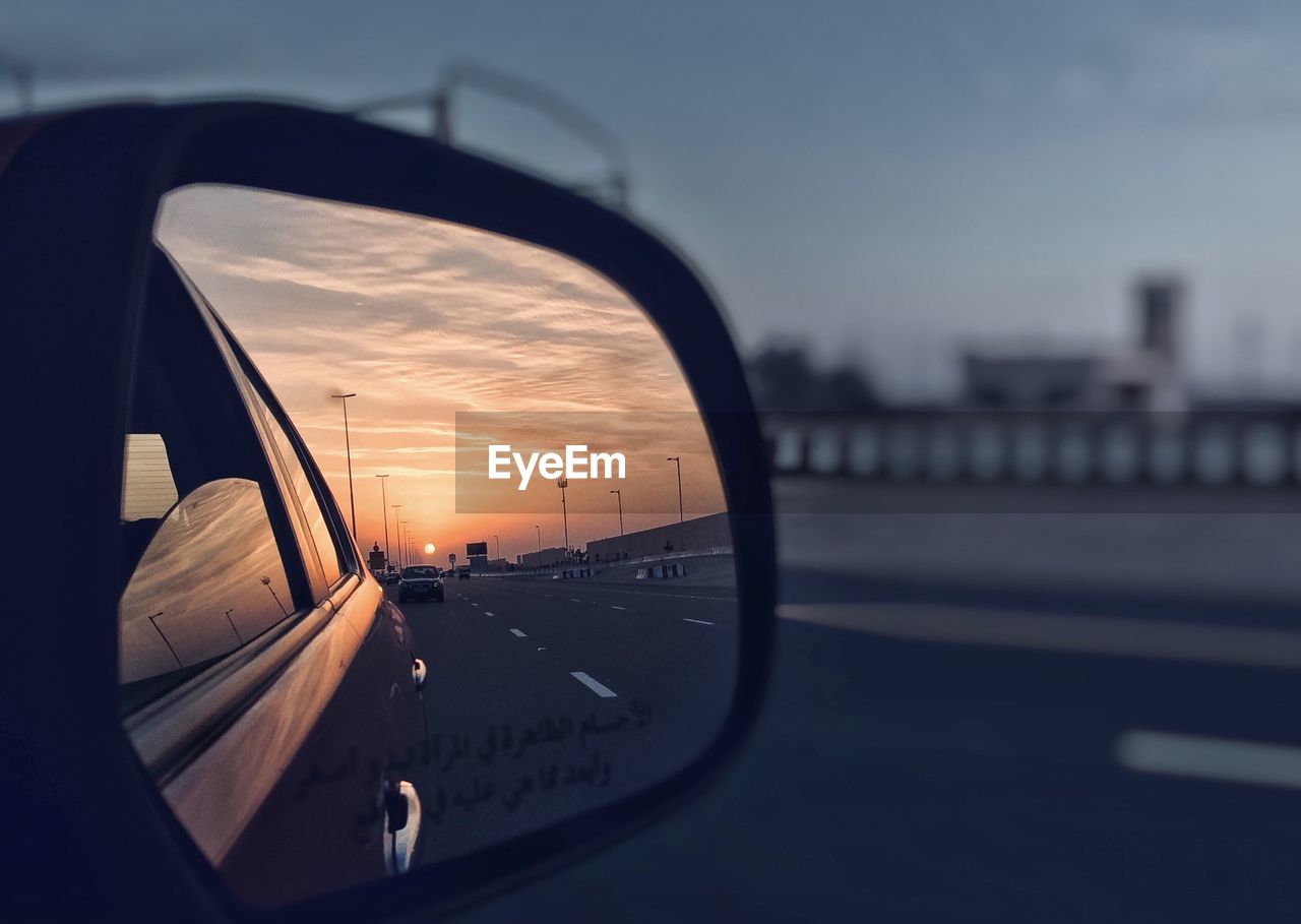 CAR ON STREET SEEN THROUGH WINDSHIELD