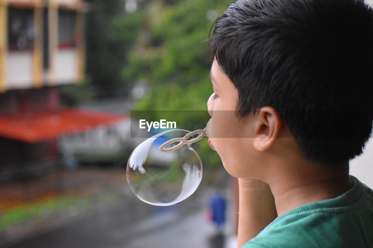 Portrait of boy holding bubbles