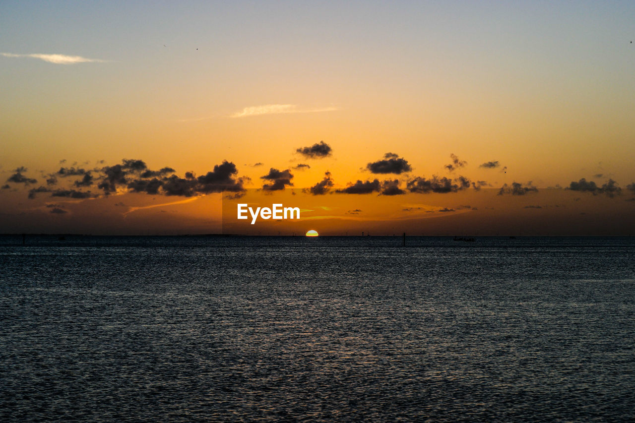 View of calm sea at sunset