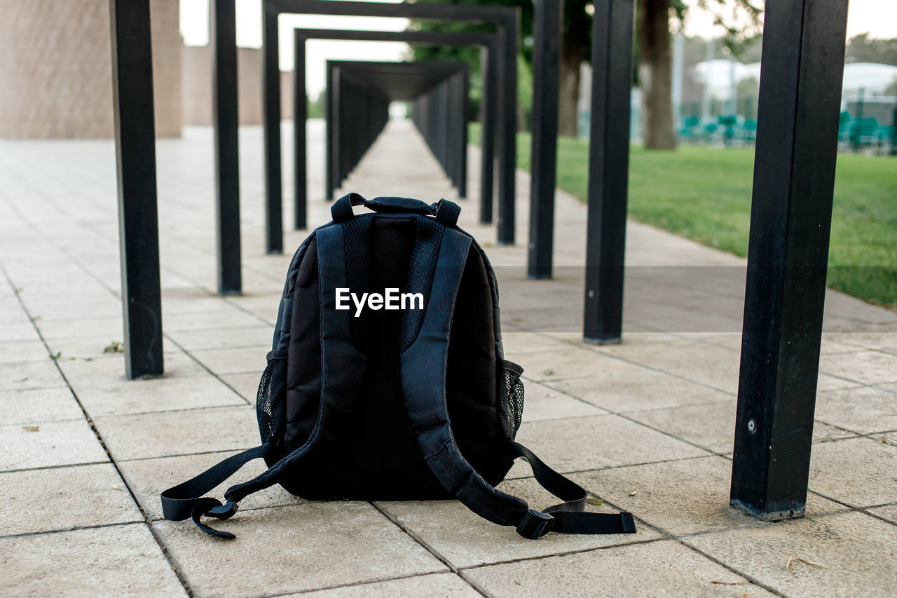 Black backpack under metal structure