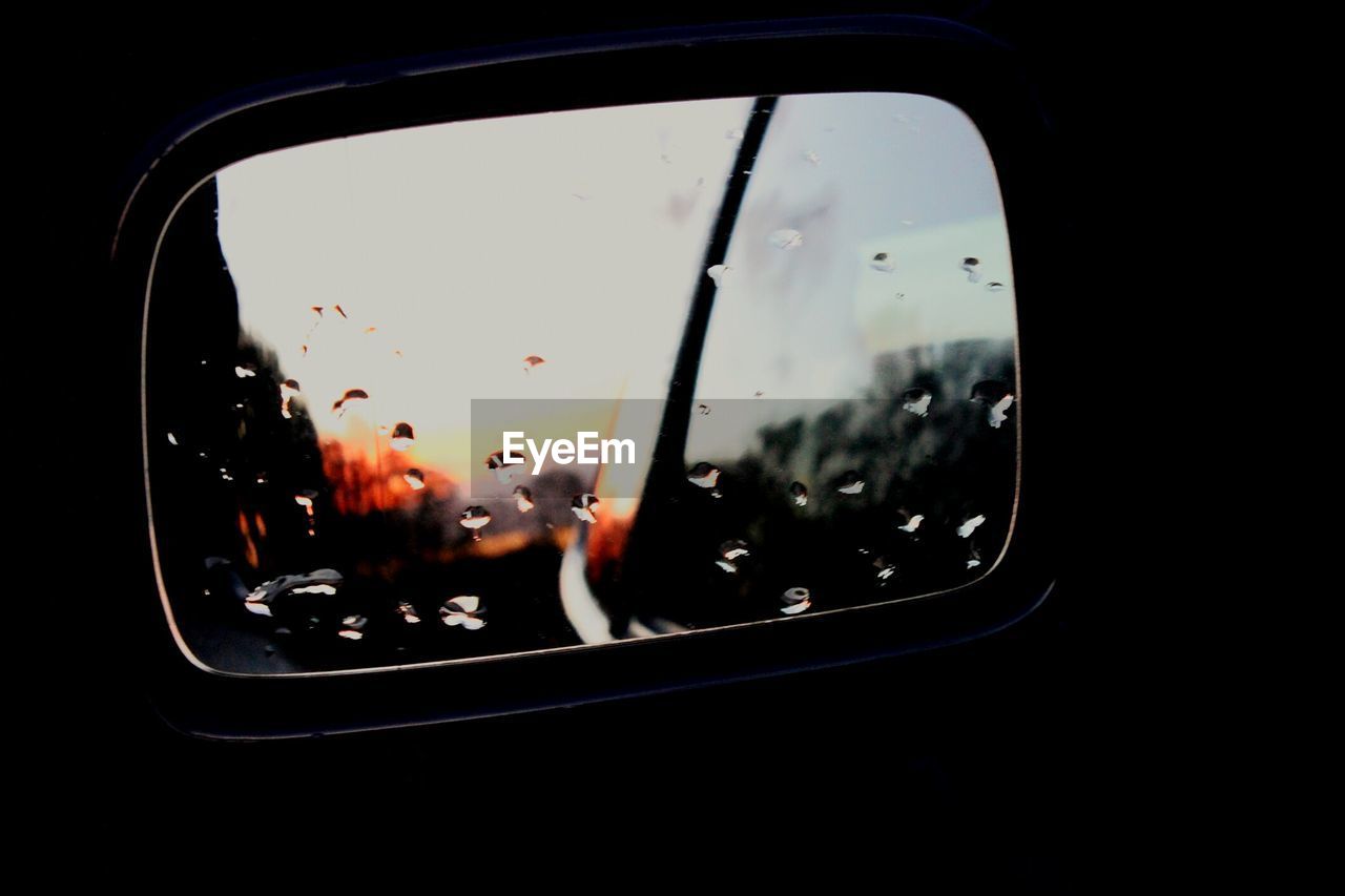 SUNSET SEEN THROUGH CAR WINDSHIELD