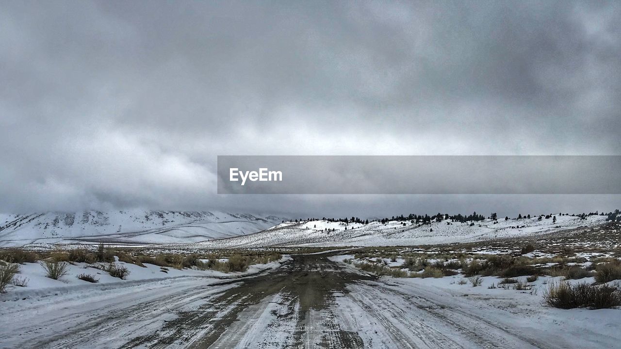 Snow covered road against sky