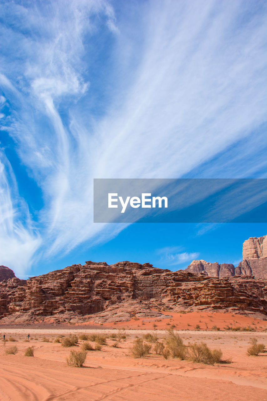 View of desert against cloudy sky