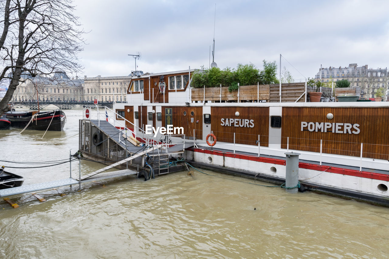 BOAT MOORED AT HARBOR