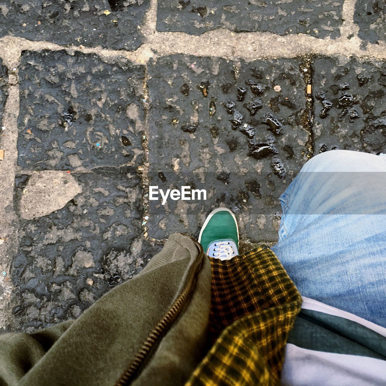 Low section of man standing on street