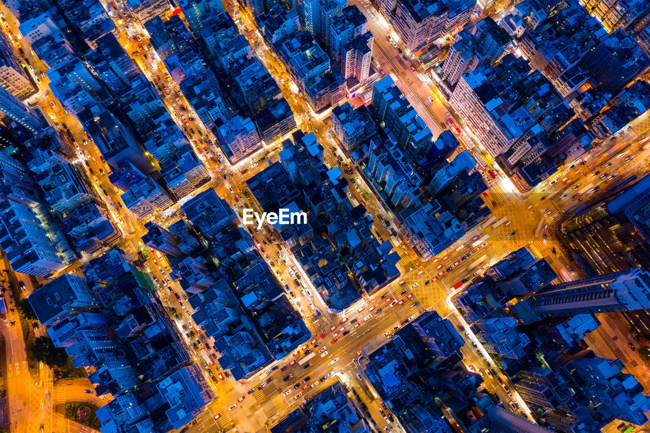 Aerial view of modern buildings in city at dusk