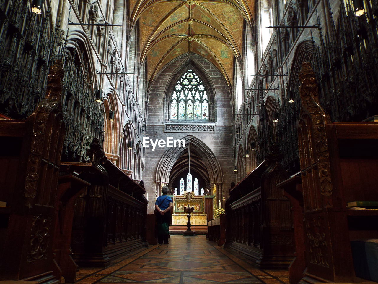 Rear view of person standing in front of church altar