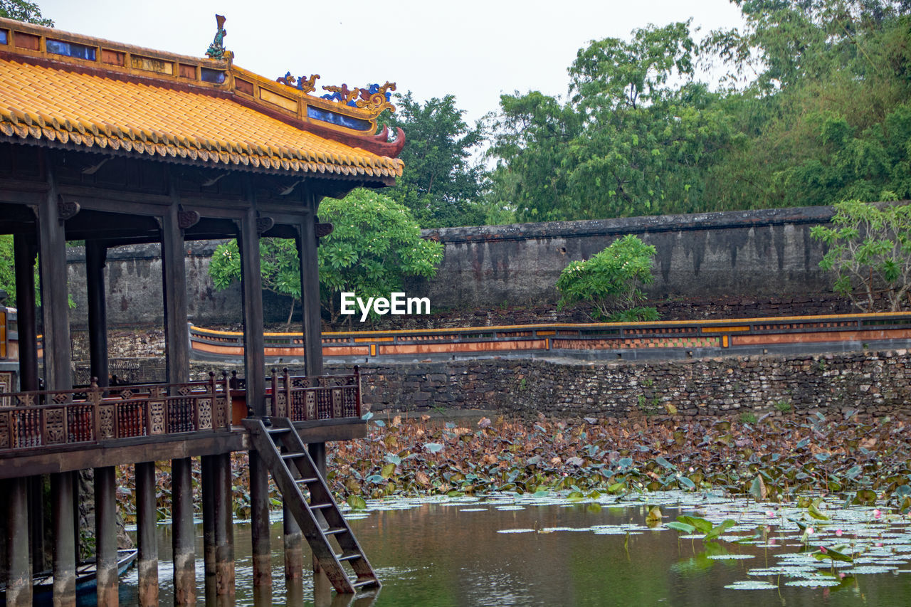 BRIDGE OVER RIVER AMIDST BUILDINGS