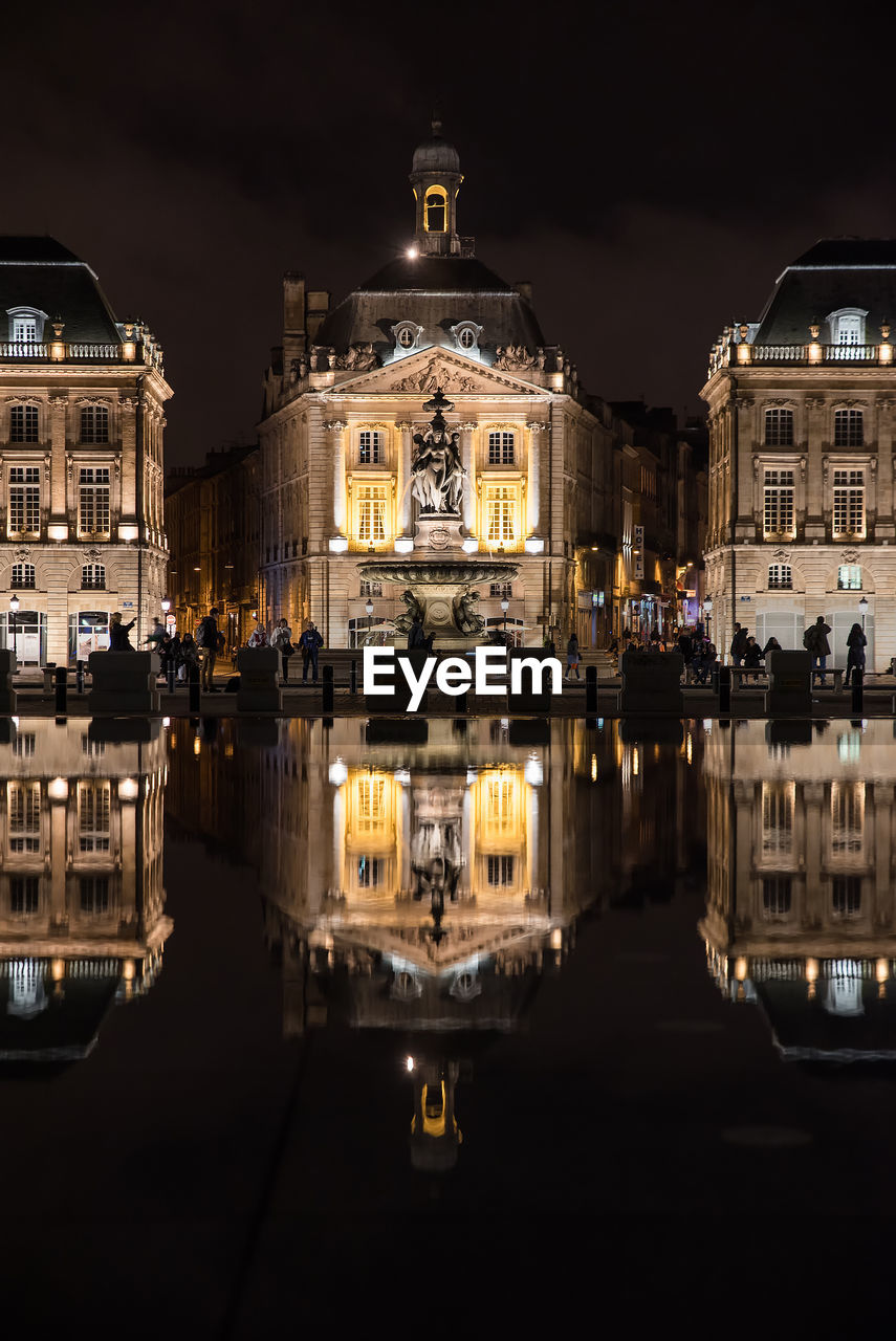 Reflection of illuminated buildings in water at night