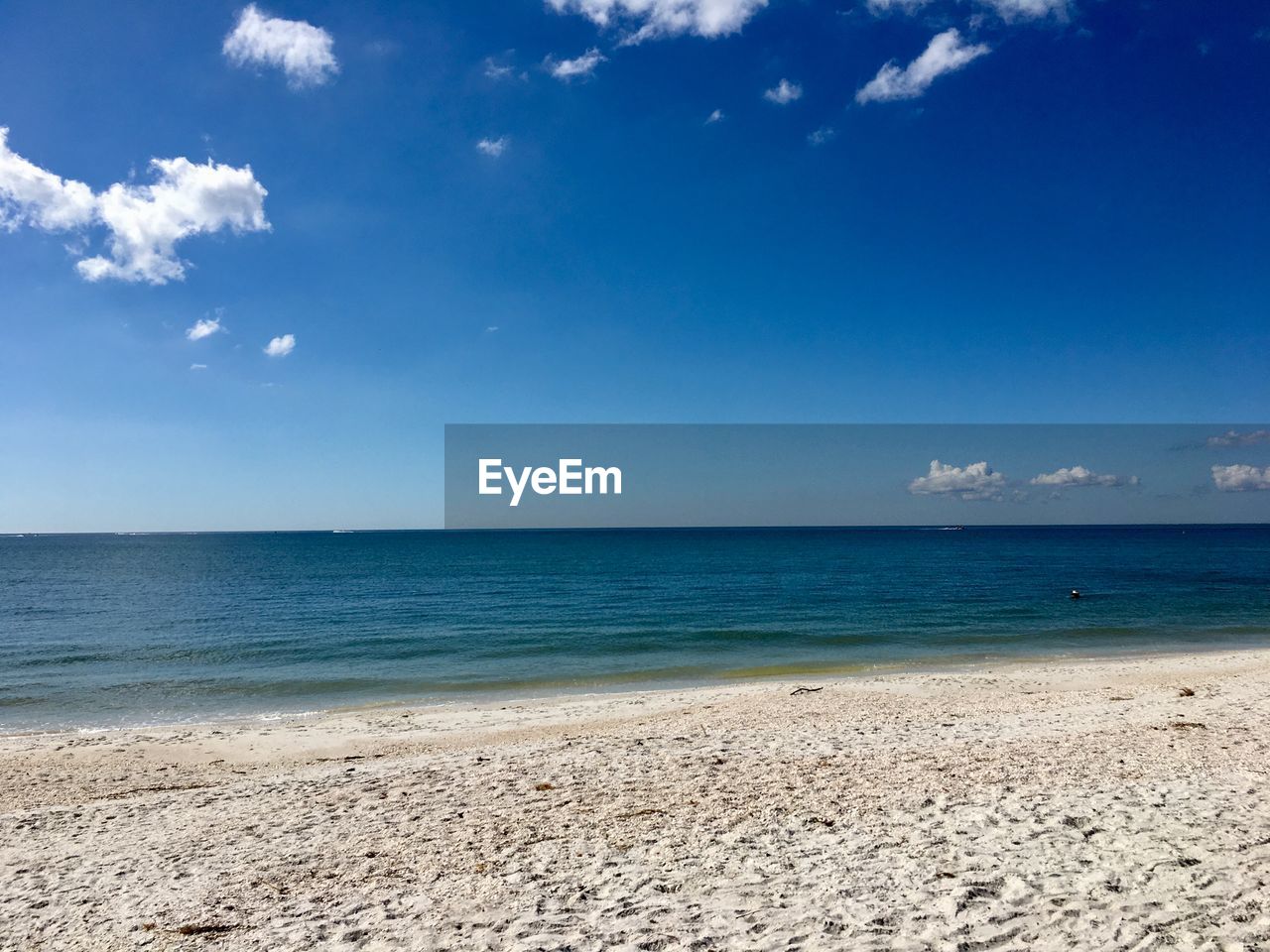 Scenic view of sea against blue sky