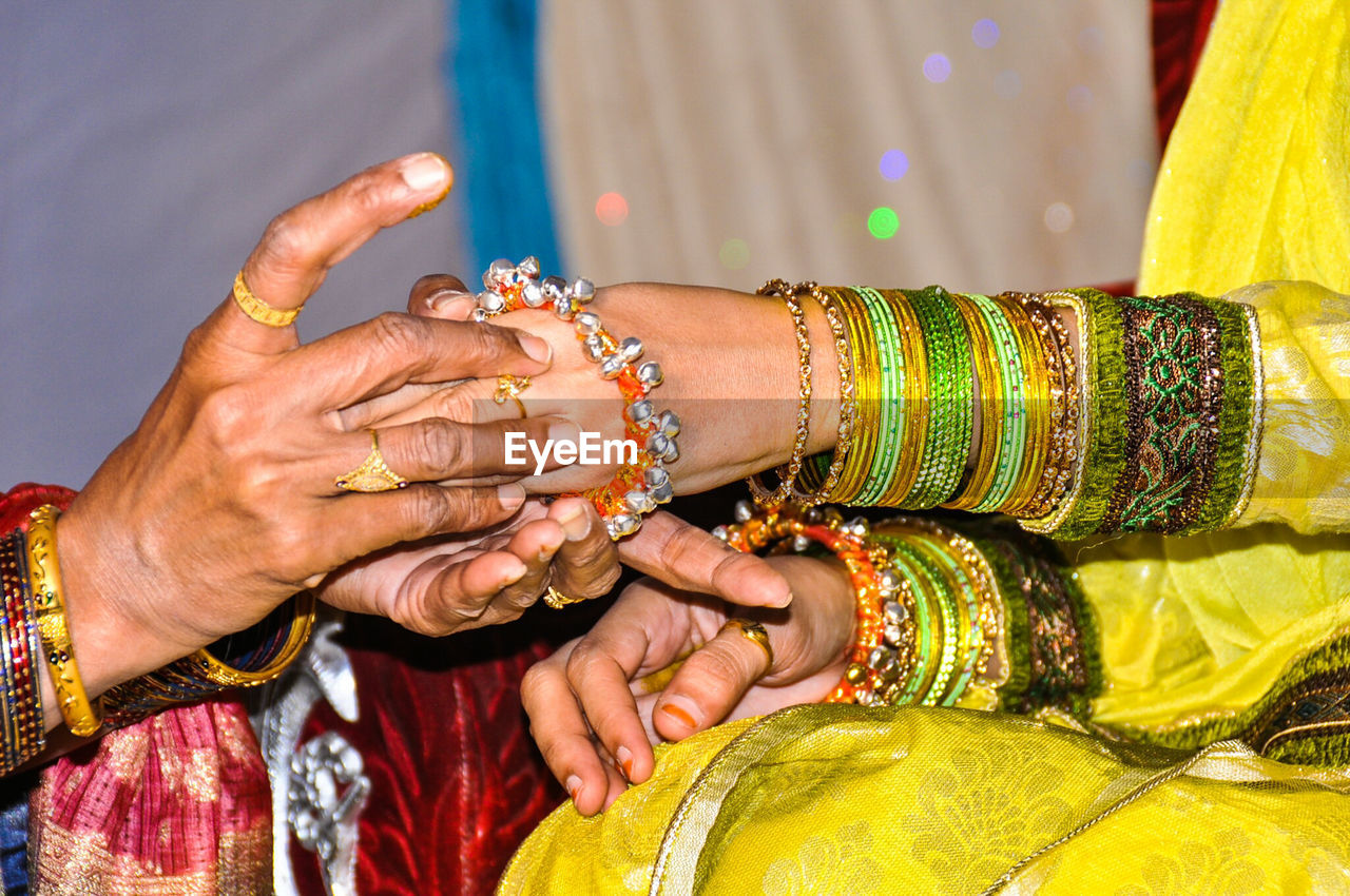 Close-up of womens hands in indian wedding ceremony