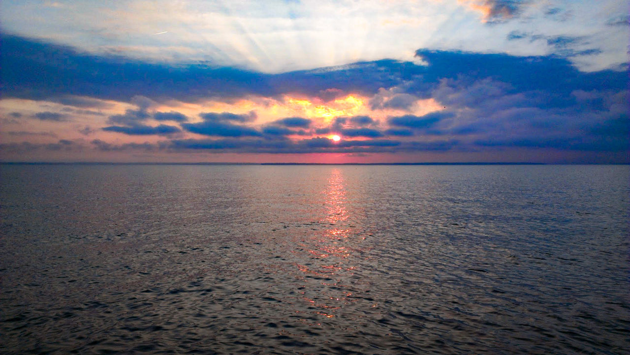 SCENIC VIEW OF SUNSET OVER SEA