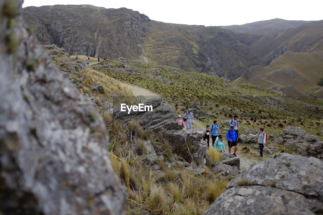 High angle view of friends hiking on mountain