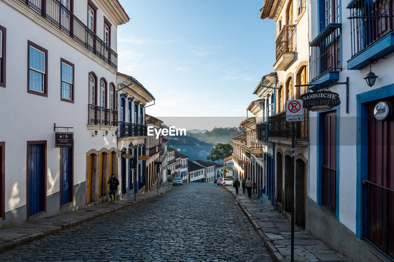 EMPTY ALLEY AMIDST BUILDINGS