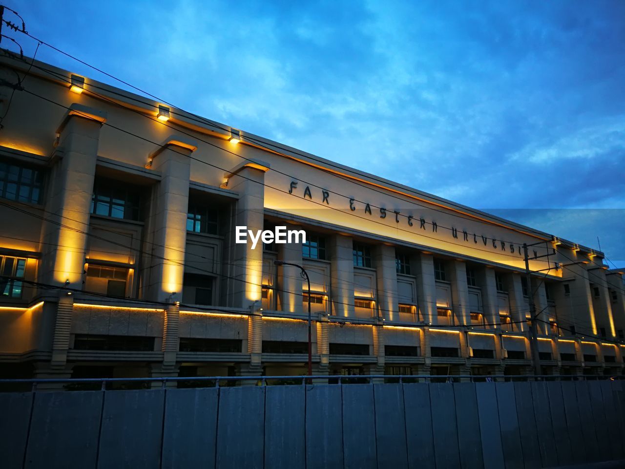 LOW ANGLE VIEW OF ILLUMINATED BUILDING AGAINST SKY