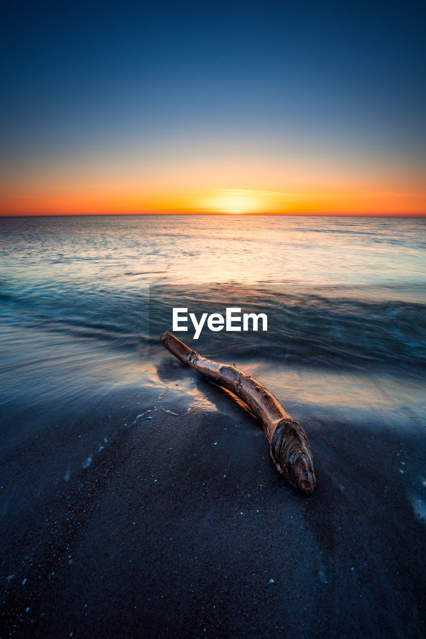 high angle view of sea against sky during sunset