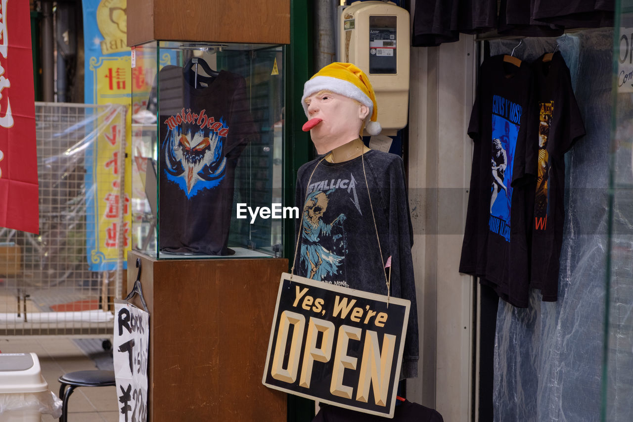 REFLECTION OF MAN ON MIRROR AT STORE