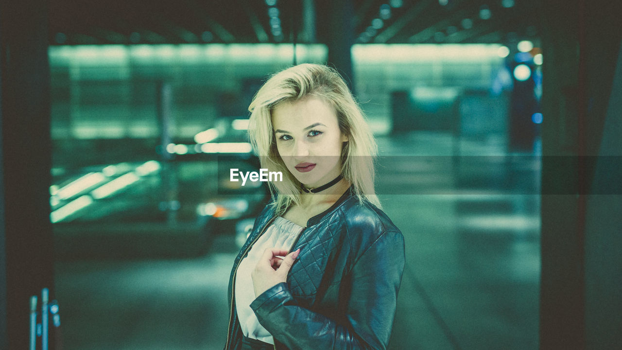 Portrait of young woman at railroad station