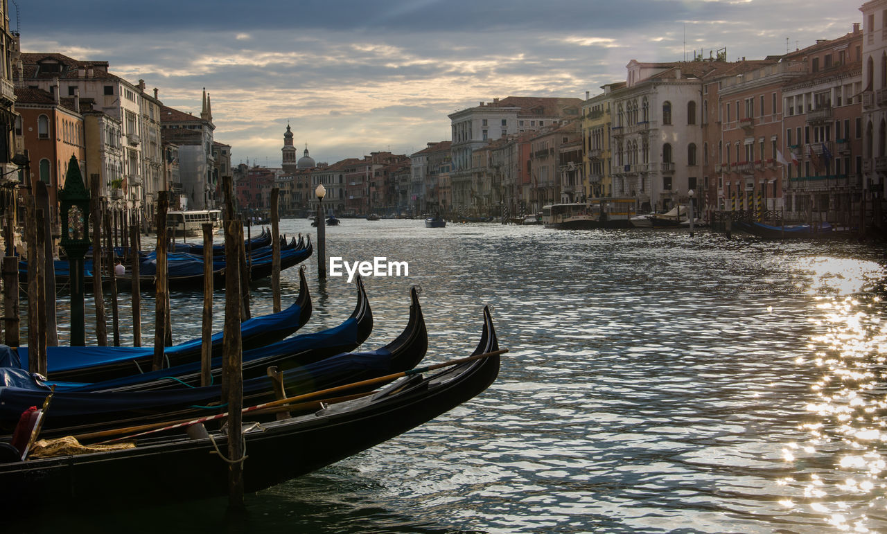 Boats in canal with buildings in background