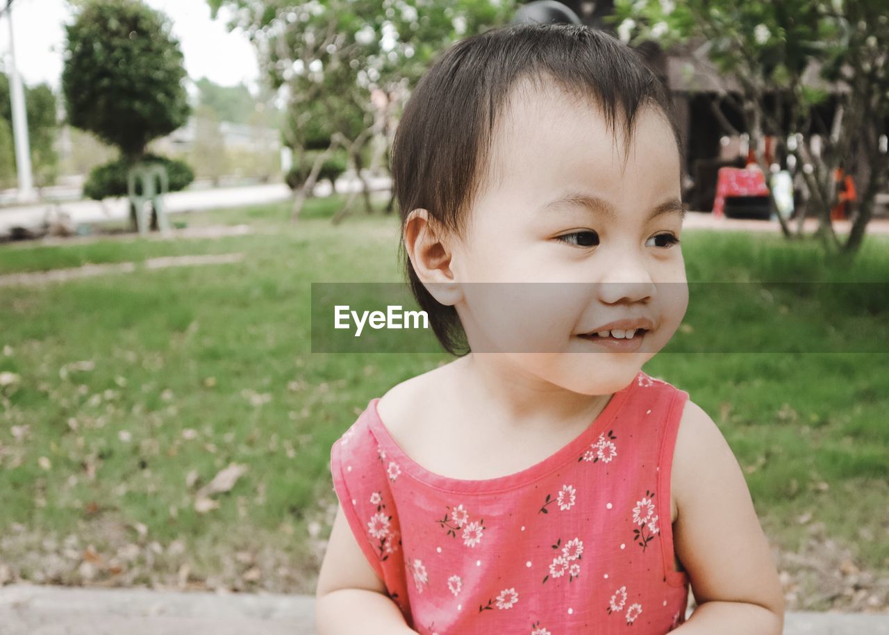 Cute little girl standing in the garden. portrait girl.