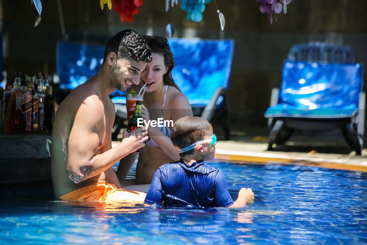 adult, men, swimming pool, emotion, women, two people, swimming, lifestyles, happiness, togetherness, child, positive emotion, water, female, fun, sports, childhood, indoors, nature, smiling, love, bonding, young adult, enjoyment, family, clothing, leisure activity, parent, person, relaxation