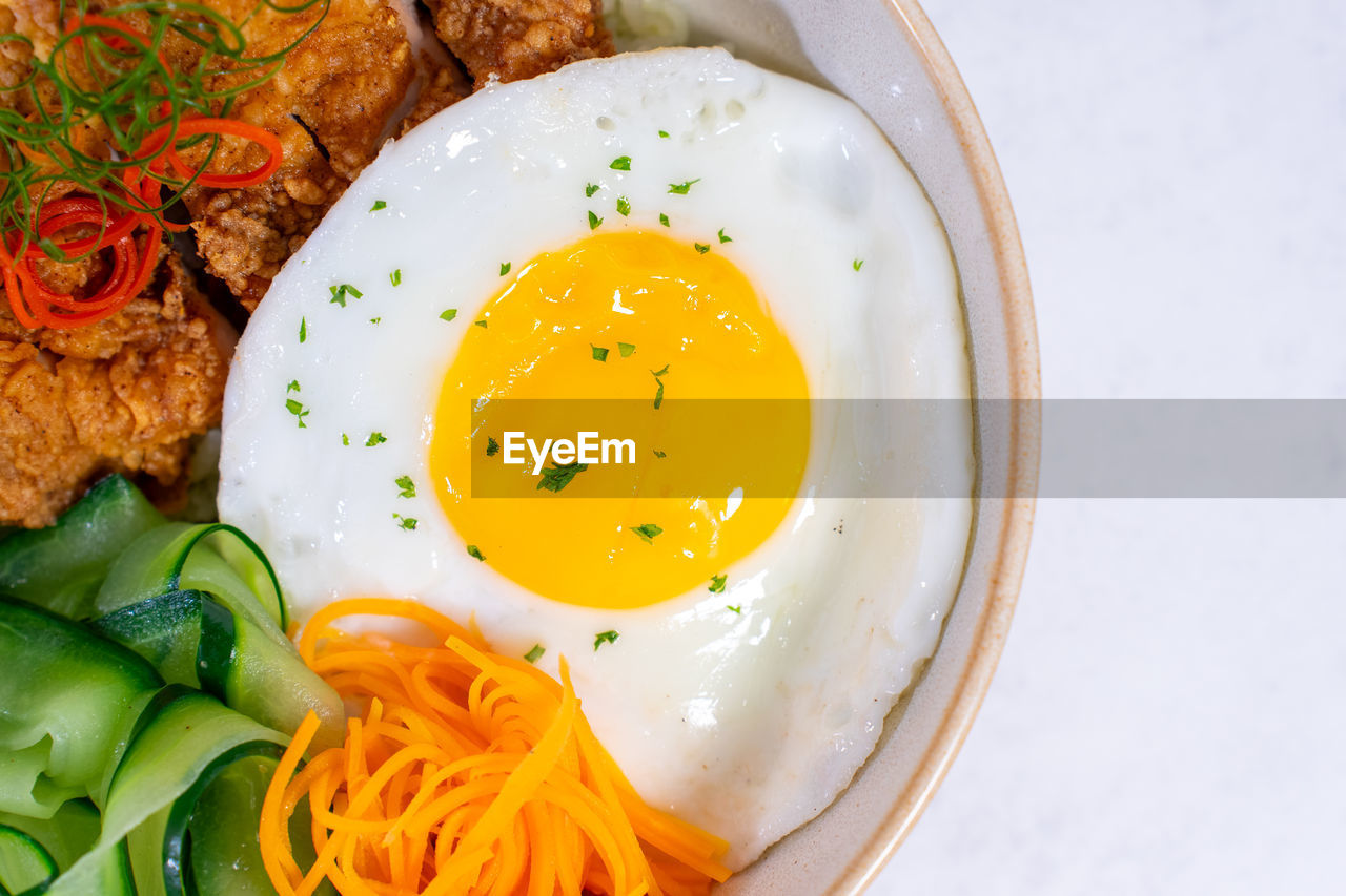 A portion of breakfast with sunny side-up eggs photographed at close range from above.