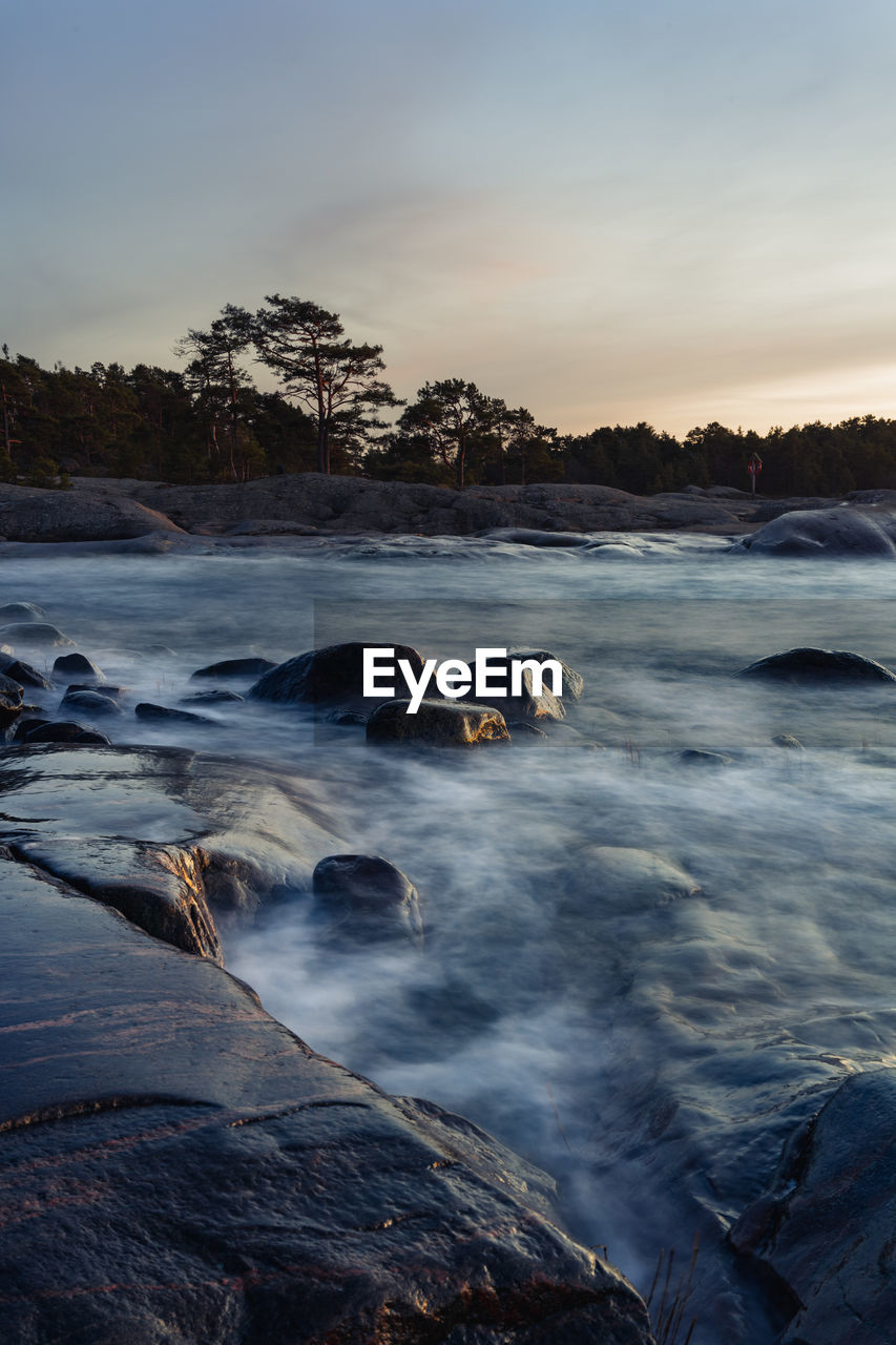 Scenic view of ocean against sky during sunset