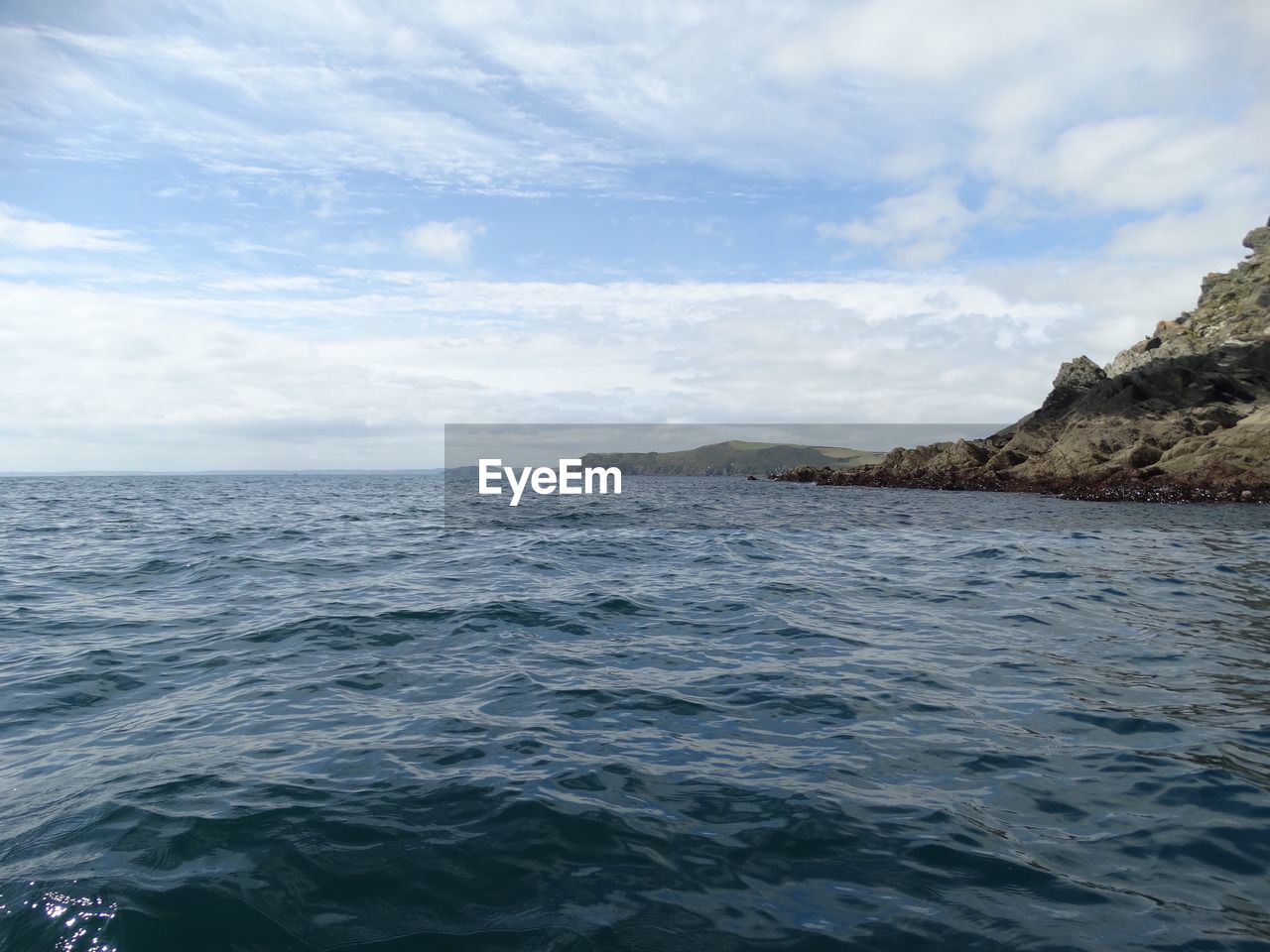 Scenic view of sea against cloudy sky