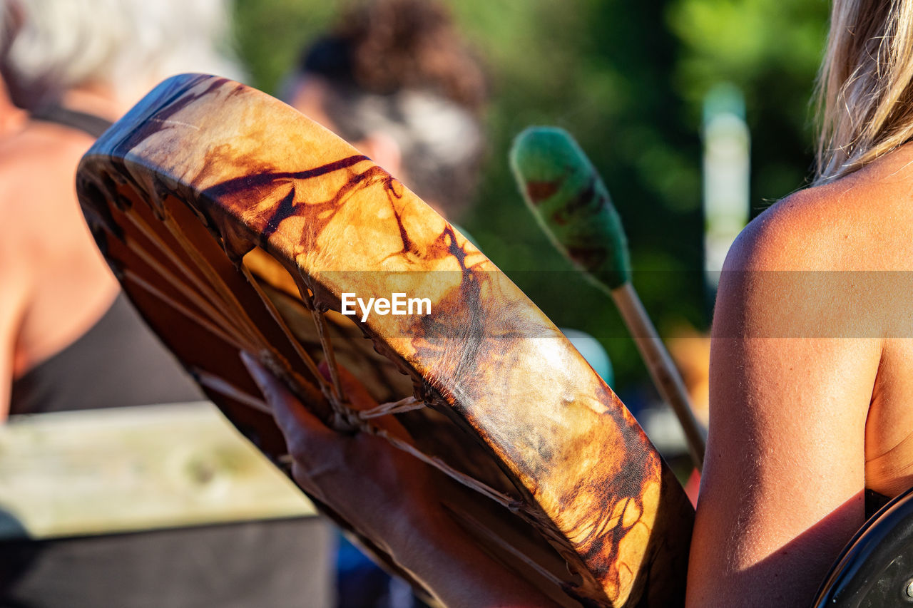 REAR VIEW OF MAN HOLDING BREAD