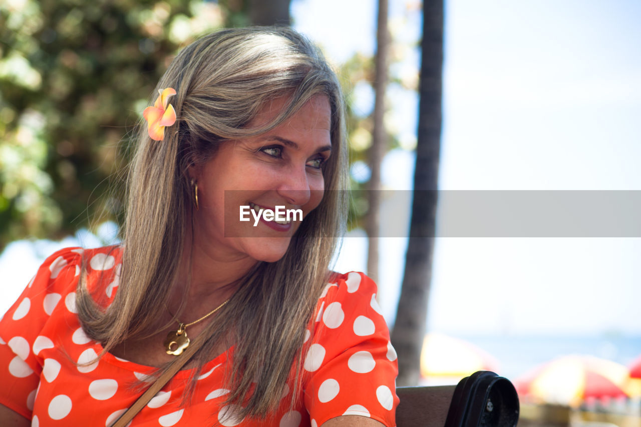 Close-up of smiling woman looking away