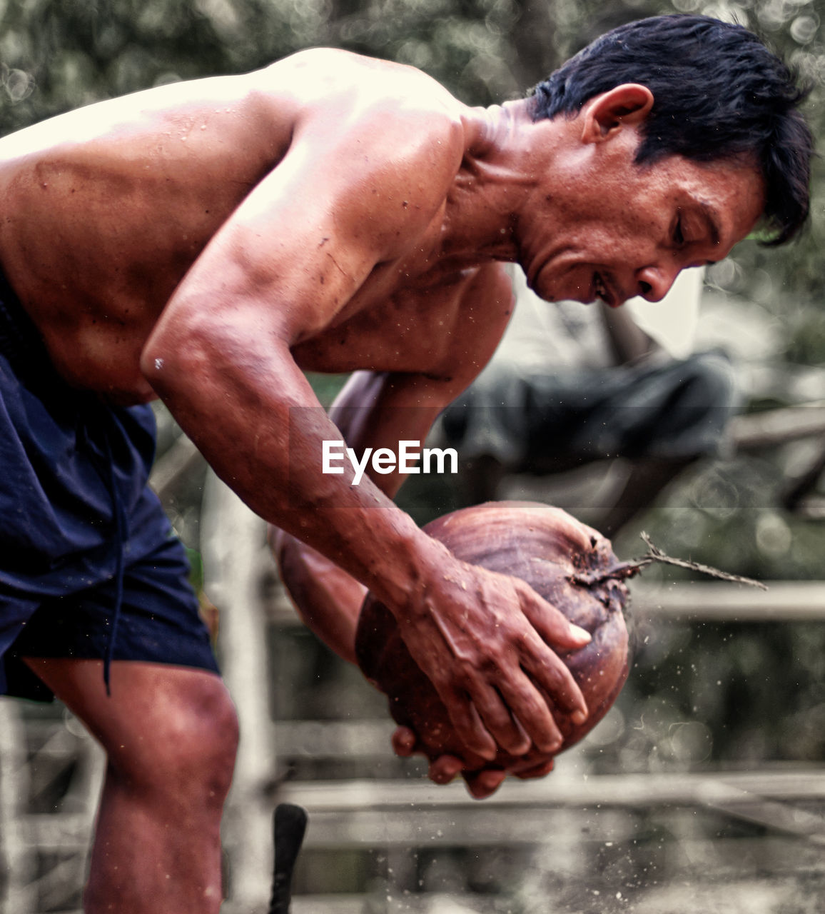 Close-up of shirtless man working outdoors