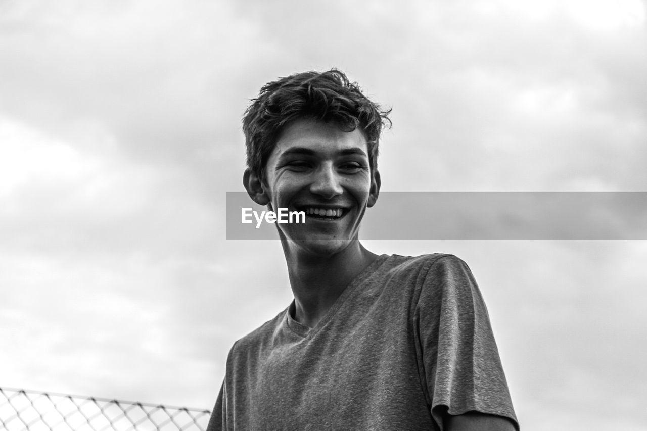 Portrait of smiling man against sky