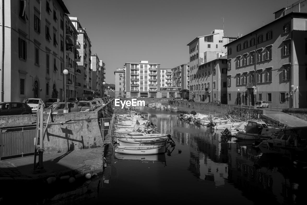 BOATS IN CANAL ALONG BUILDINGS