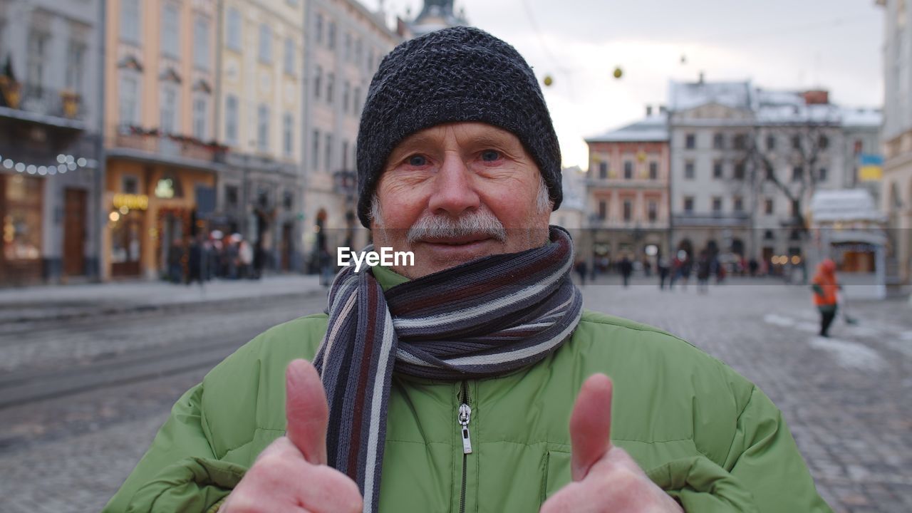 Portrait of man in city during winter