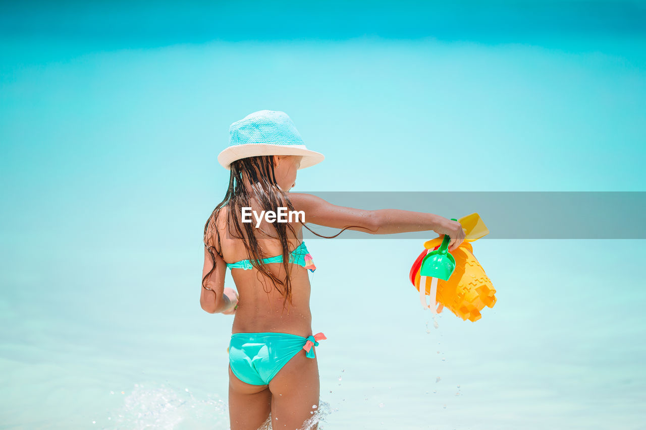 WOMAN WITH UMBRELLA ON BEACH