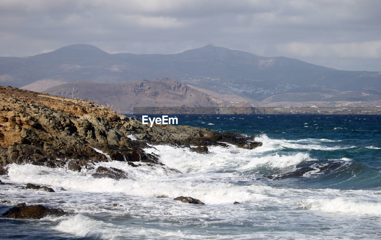 water, sea, ocean, wave, coast, shore, scenics - nature, mountain, body of water, beauty in nature, land, nature, motion, sky, wind wave, environment, cloud, rock, beach, sports, no people, water sports, outdoors, mountain range, landscape, day, travel destinations, bay, winter, travel, non-urban scene, snow, splashing, coastline, horizon