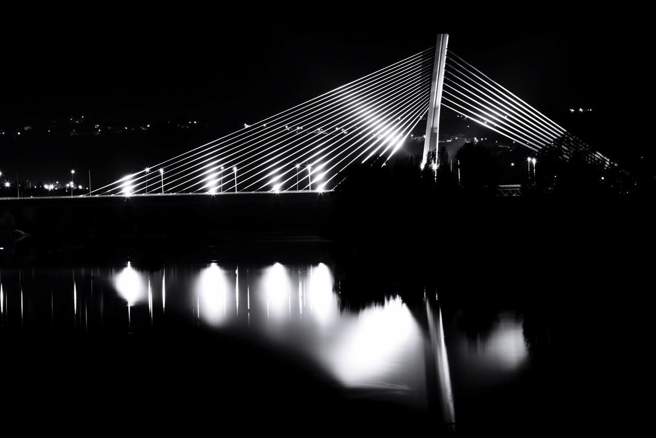 ILLUMINATED SUSPENSION BRIDGE AT NIGHT