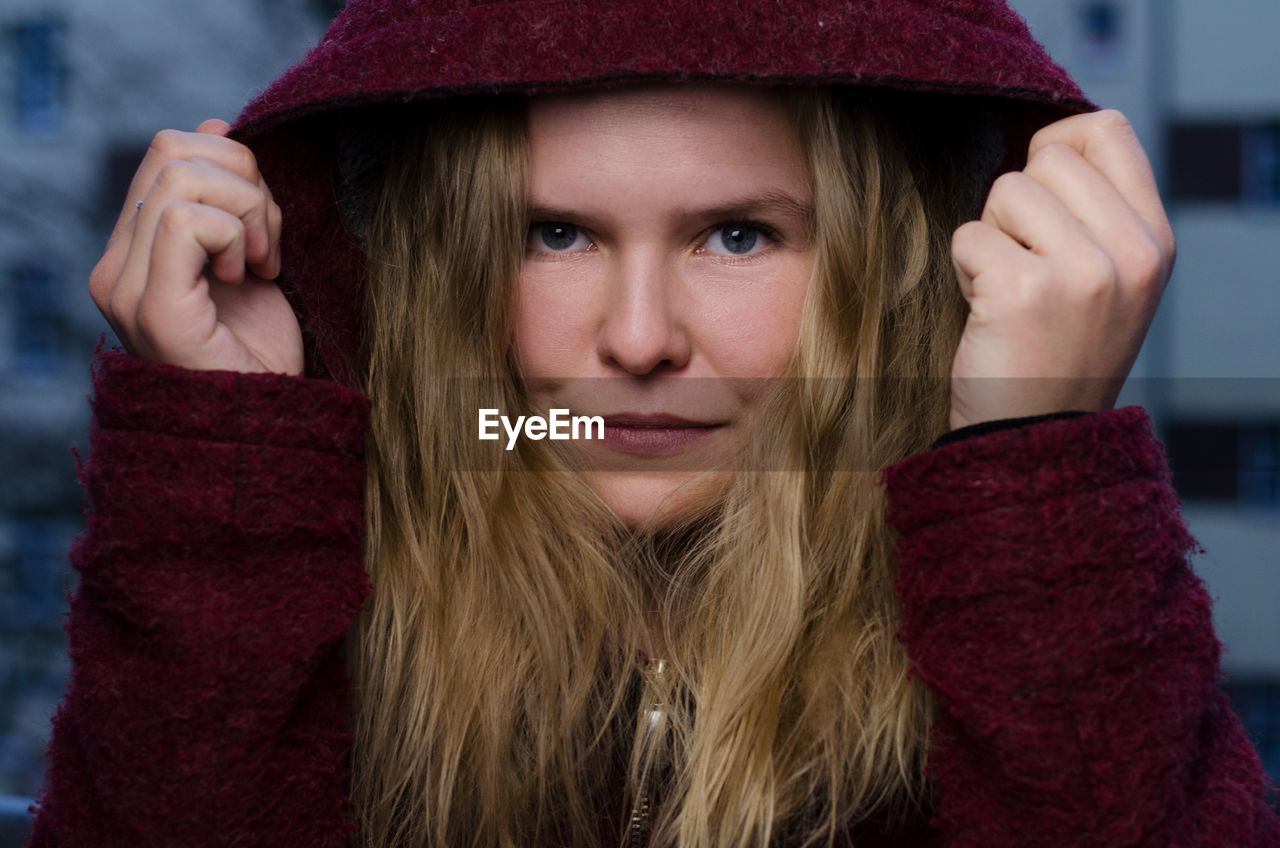 Close-up portrait of young woman wearing hood clothing during winter