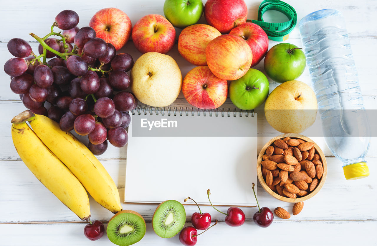 HIGH ANGLE VIEW OF FRUITS IN CONTAINER ON TABLE