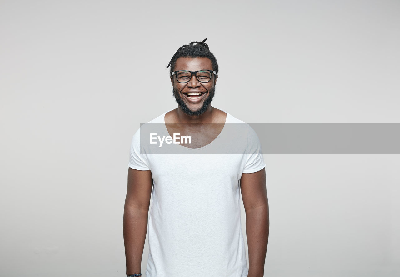 Portrait of laughing man wearing glasses and white t-shirt