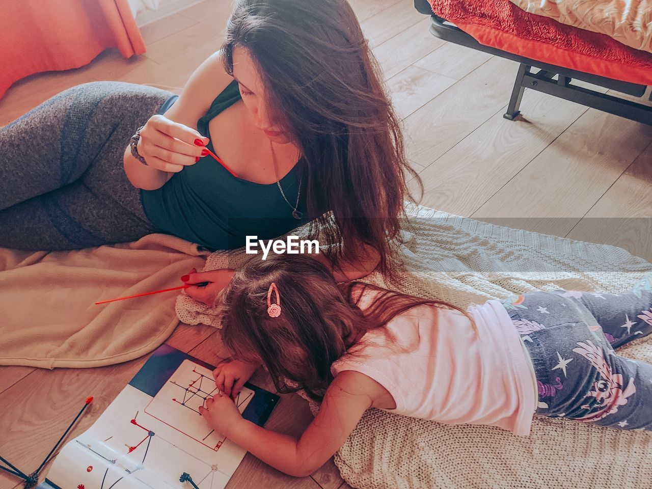 High angle view of mother with daughter making model at home