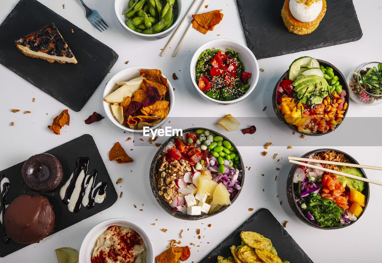 Variety of healthy and delicious poke basins on the restaurant table