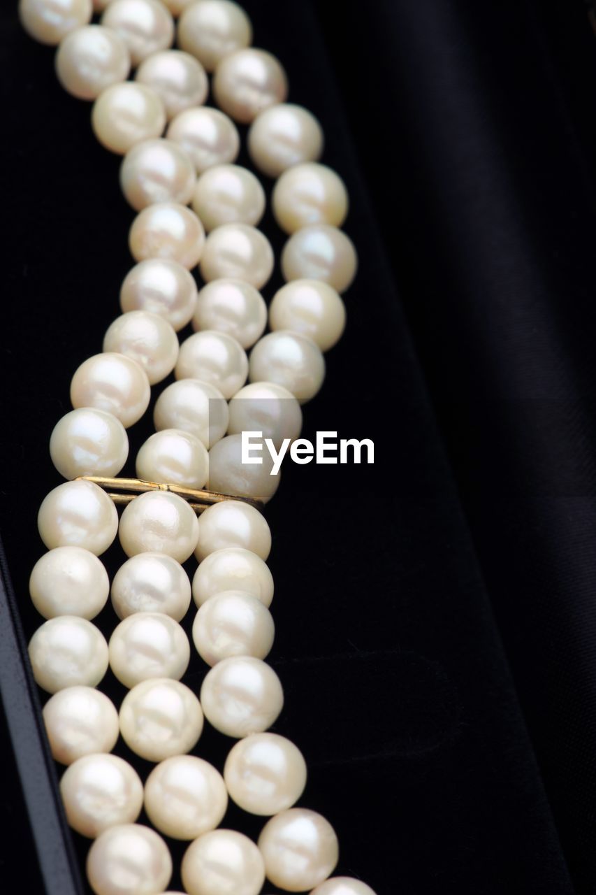 Close-up of pearl necklaces in box