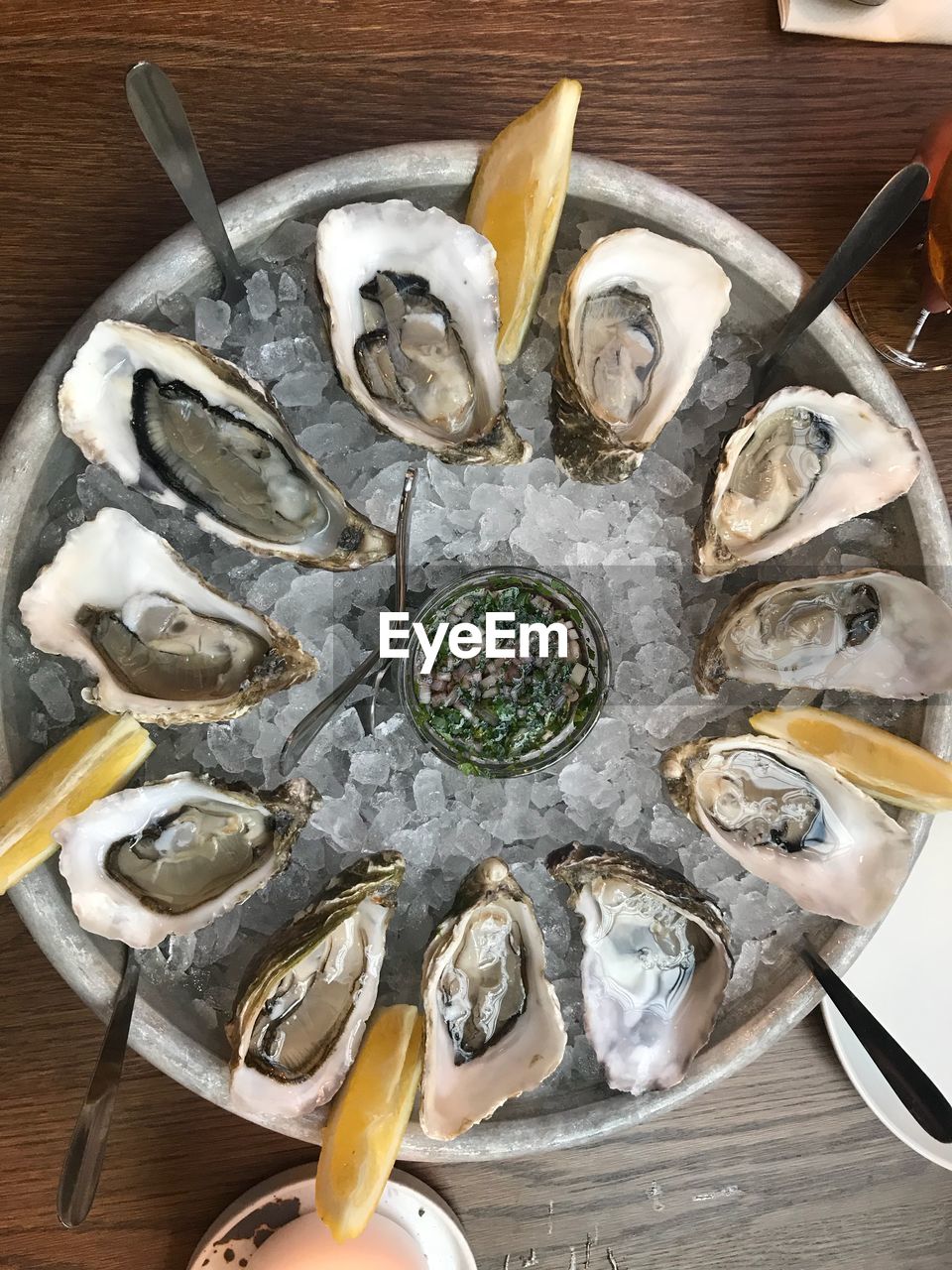 High angle view of mussels with ice in bowl on table