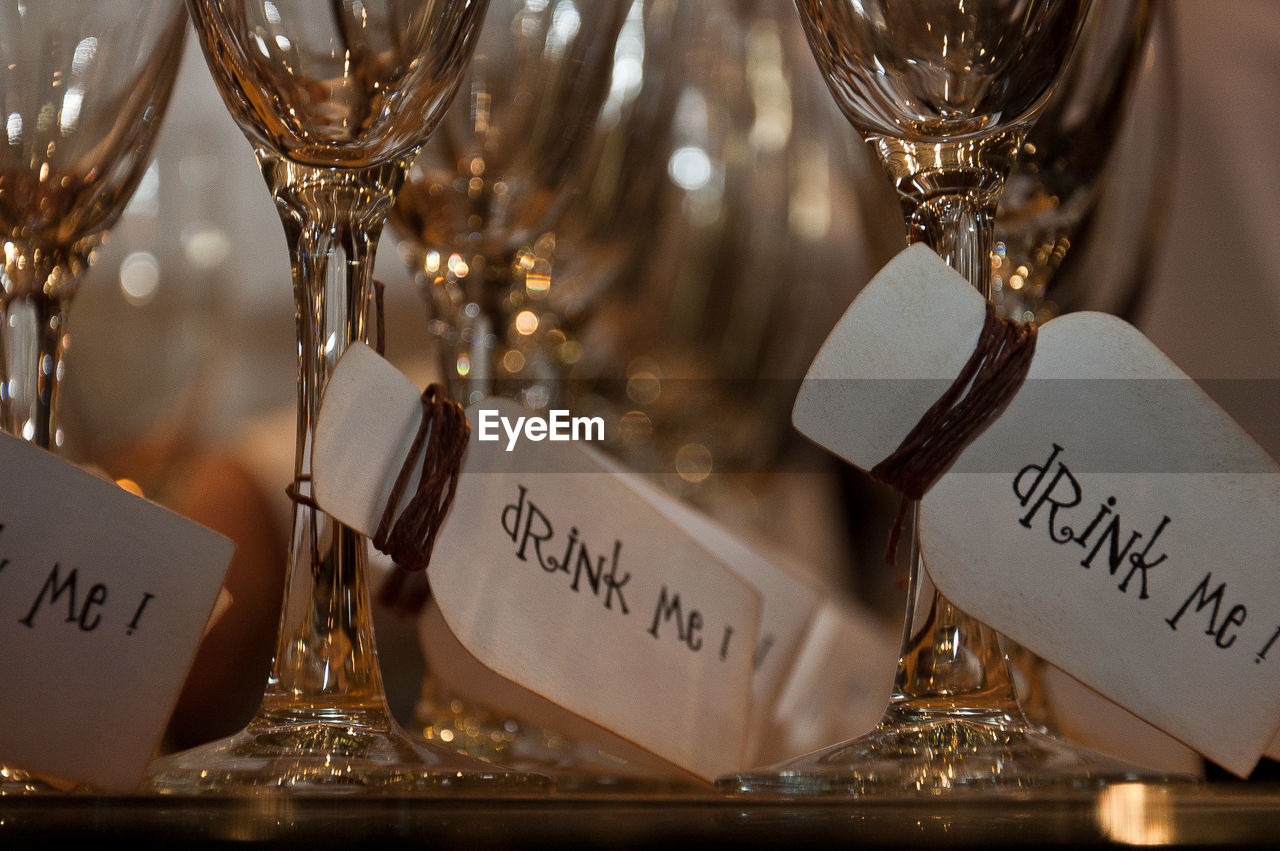 Close-up of label hanging in wineglass