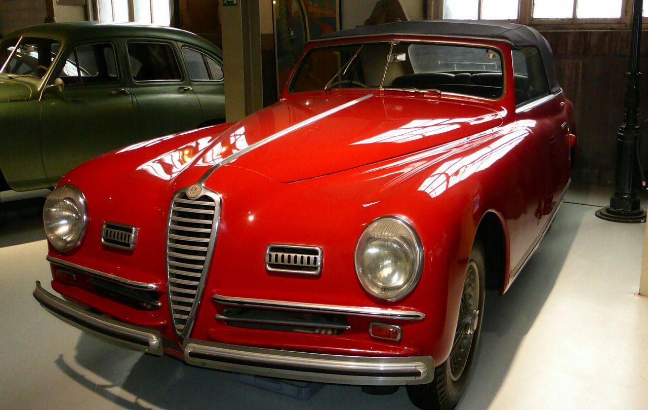 RED VINTAGE CAR ON ROAD