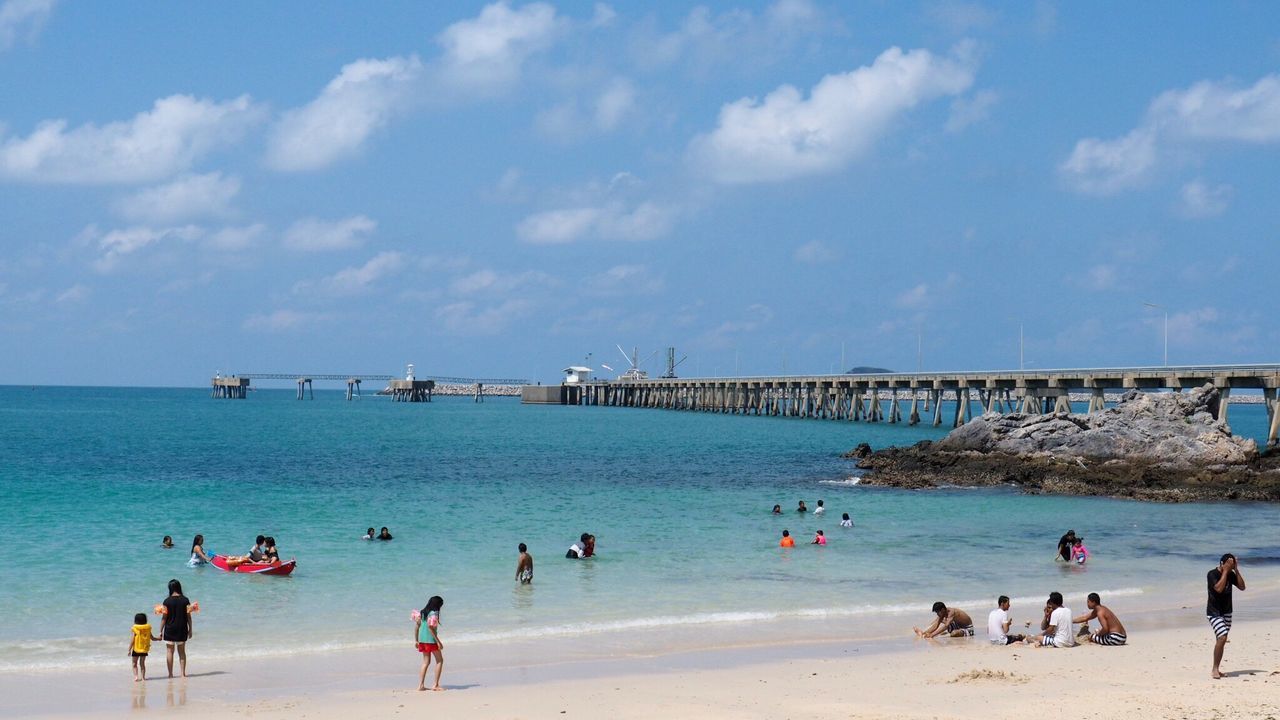 People on beach against sky