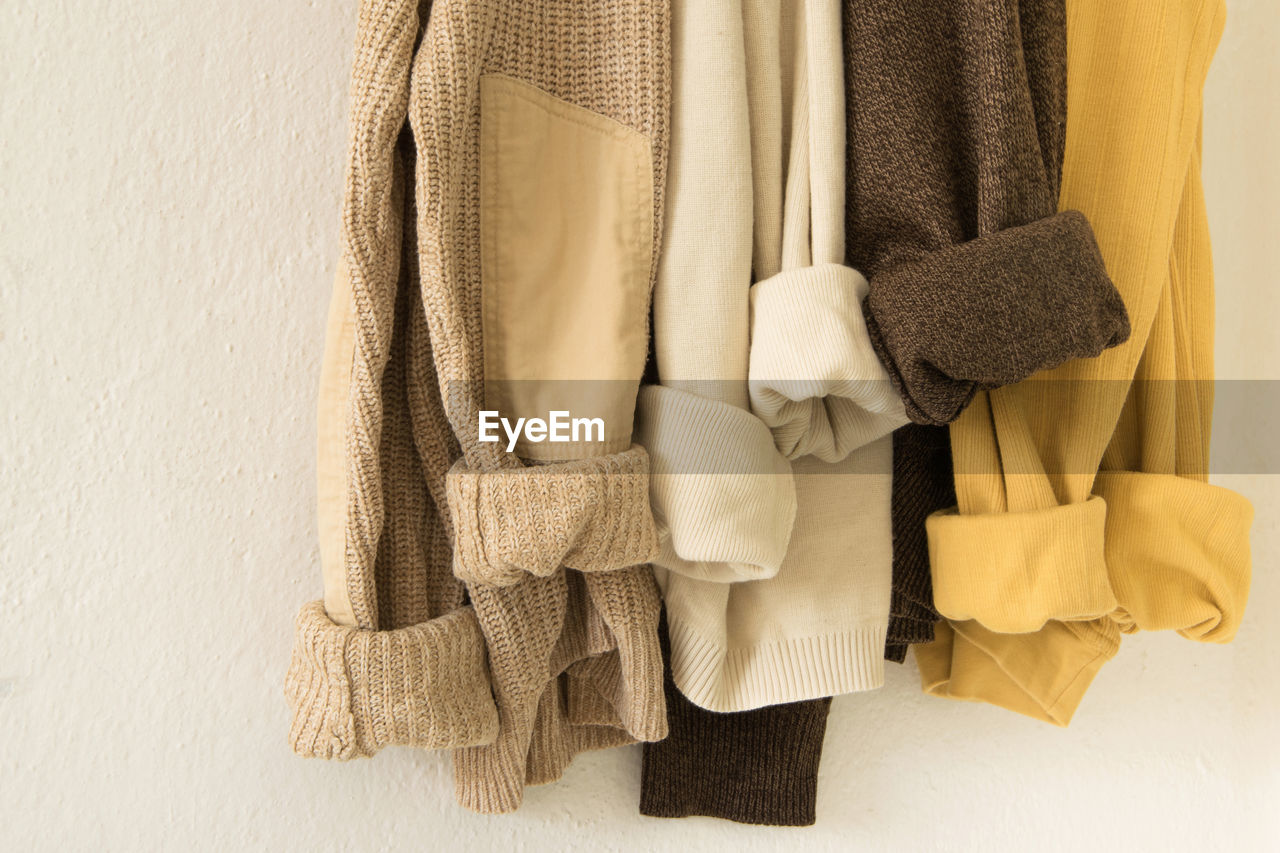 Close-up of clothes hanging against wall