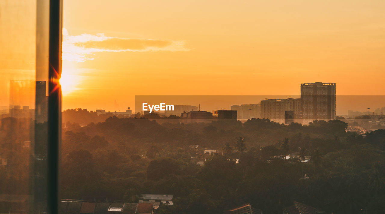 Cityscape against sky during sunset